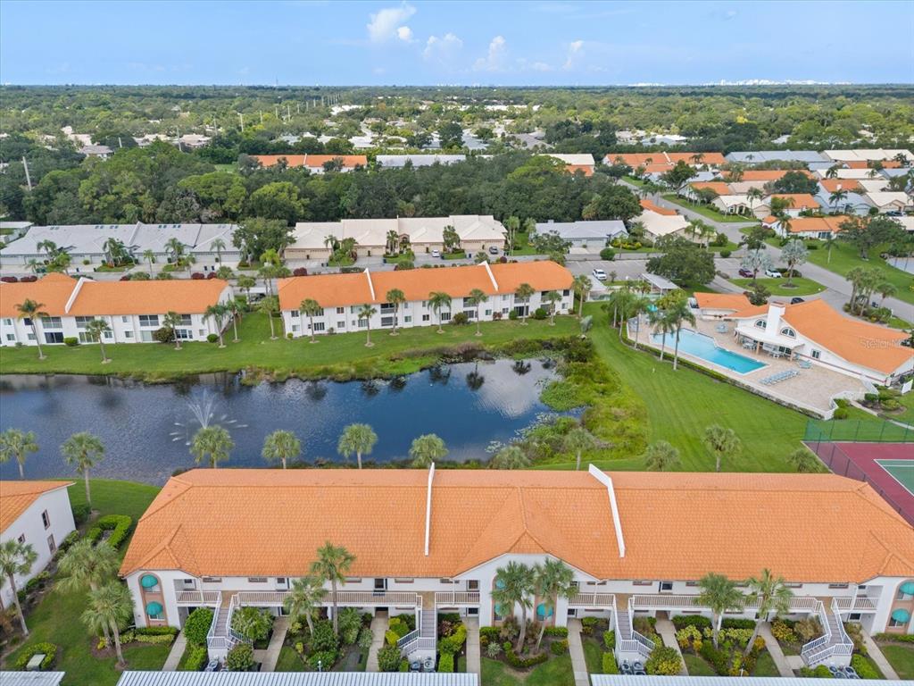 an aerial view of residential houses with outdoor space and lake view