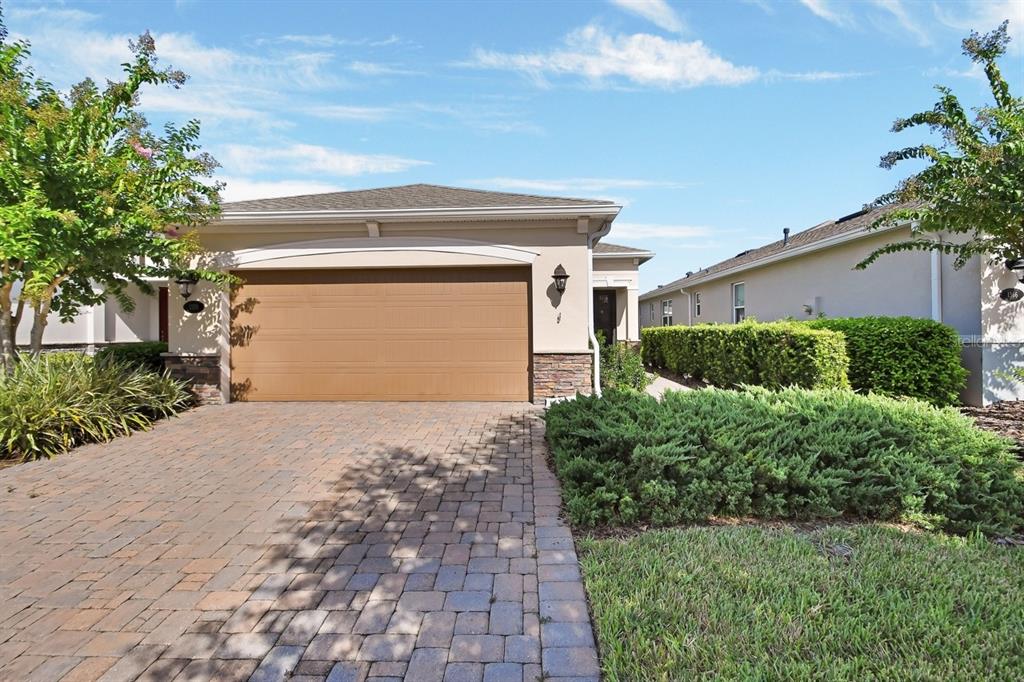 a front view of a house with a yard and garage