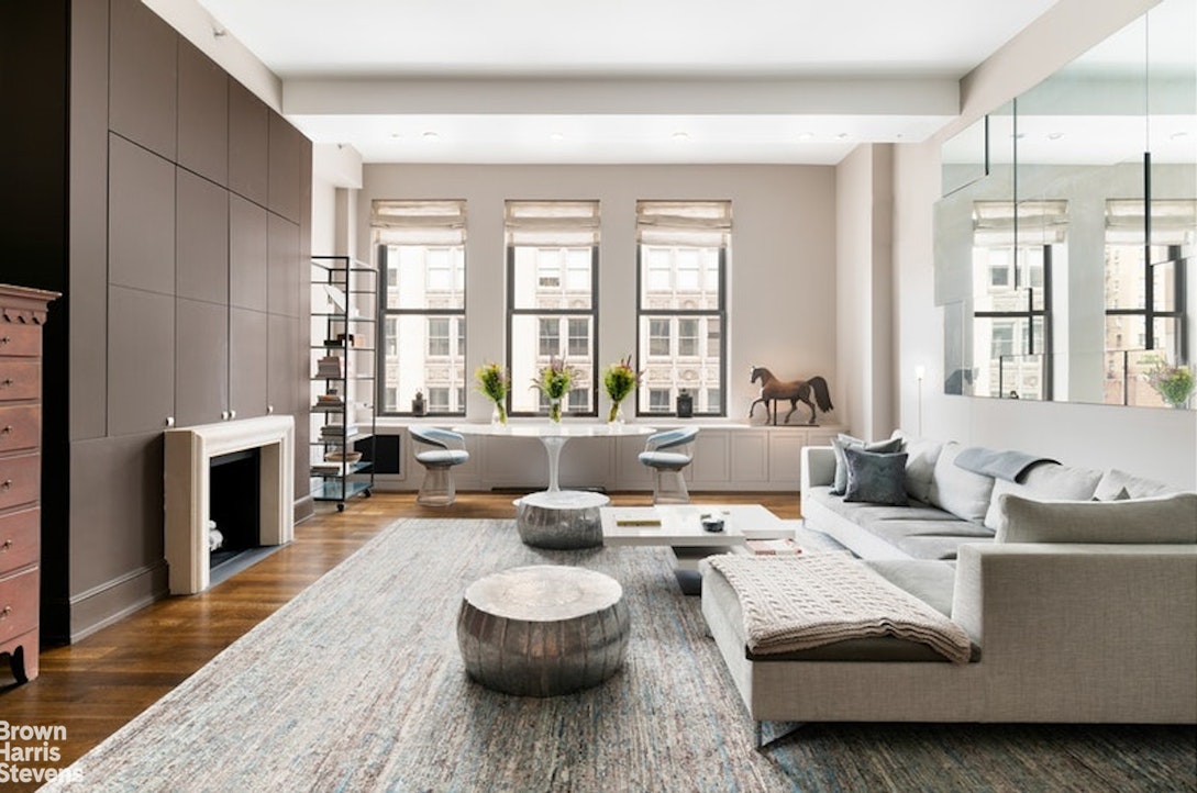 a living room with furniture and a fireplace