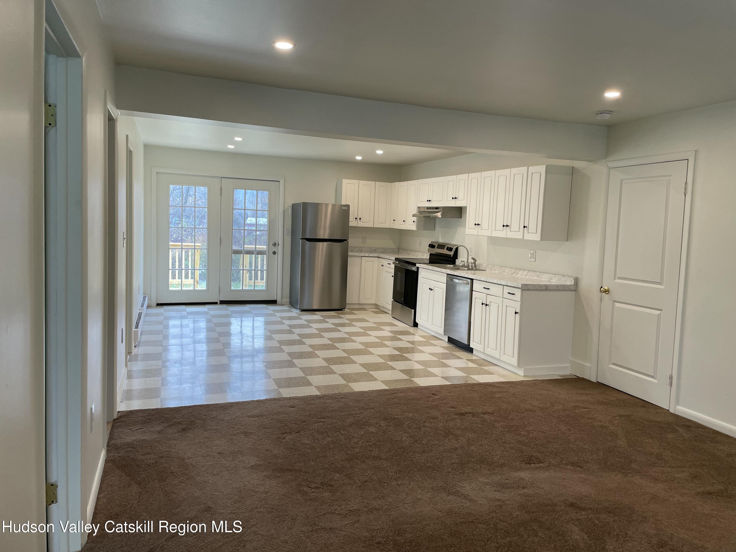 a kitchen with kitchen island a sink stainless steel appliances and cabinets