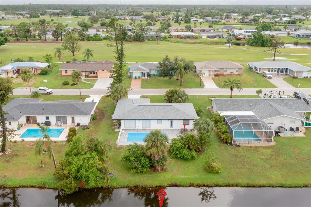 an aerial view of residential houses with outdoor space