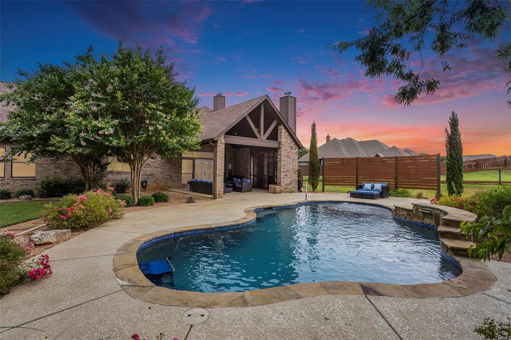 a view of a house with backyard and sitting area