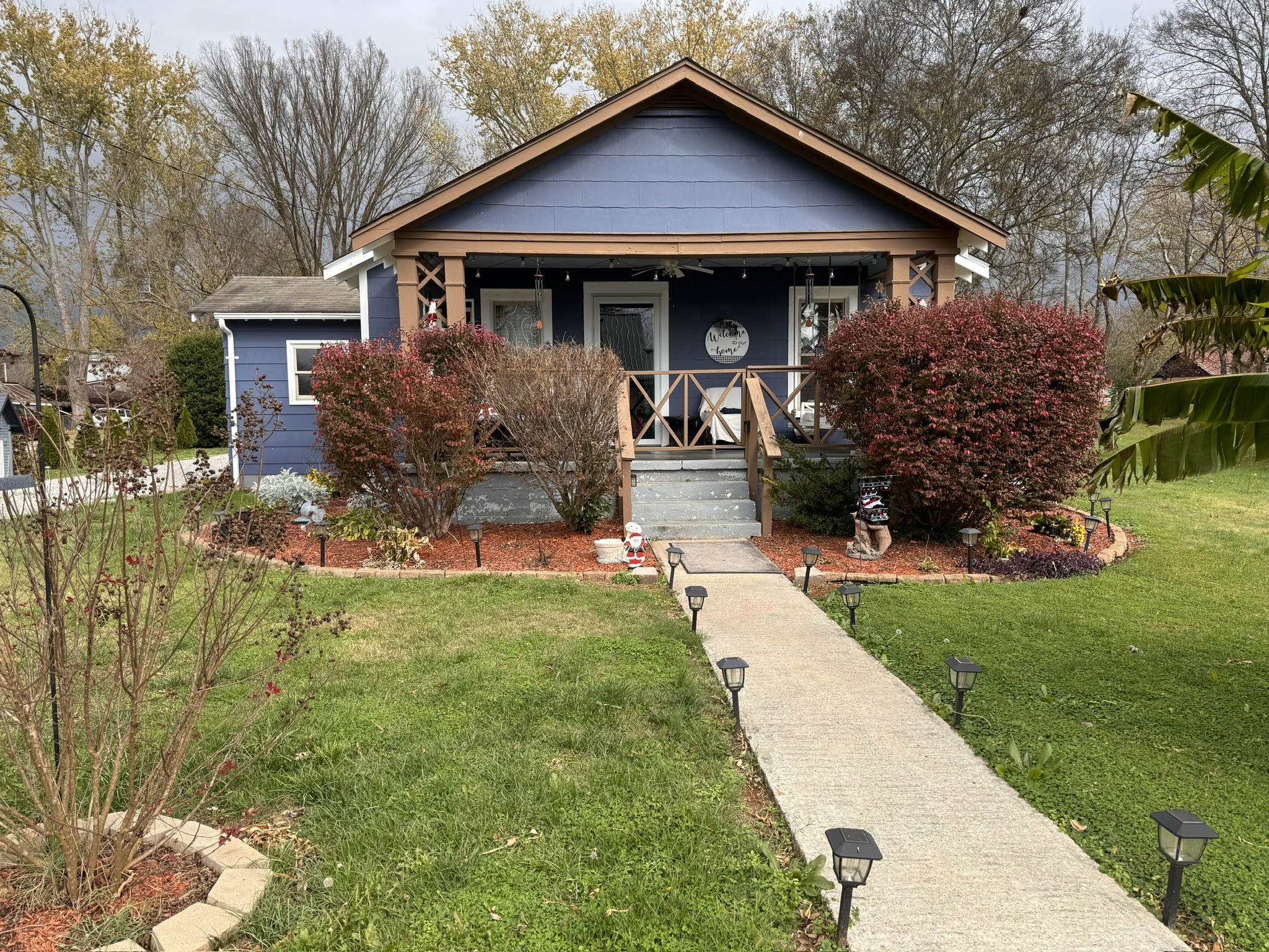 a front view of house with yard and green space