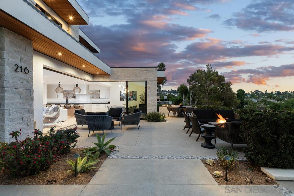 a view of a patio with table and chairs potted plants with wooden fence