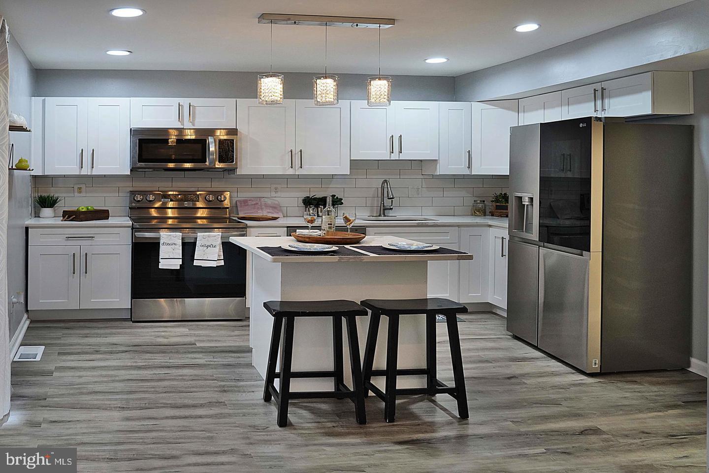 a kitchen with wooden cabinets and stainless steel appliances