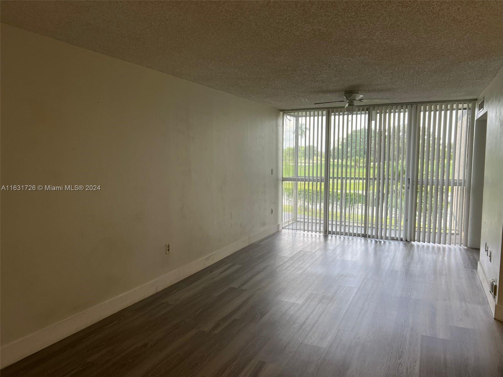 a view of wooden floor and windows in a room