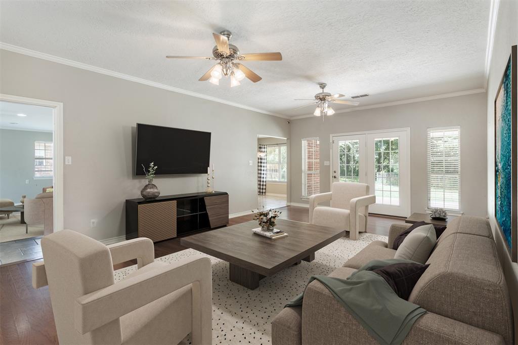 a living room with furniture a flat screen tv and a large window