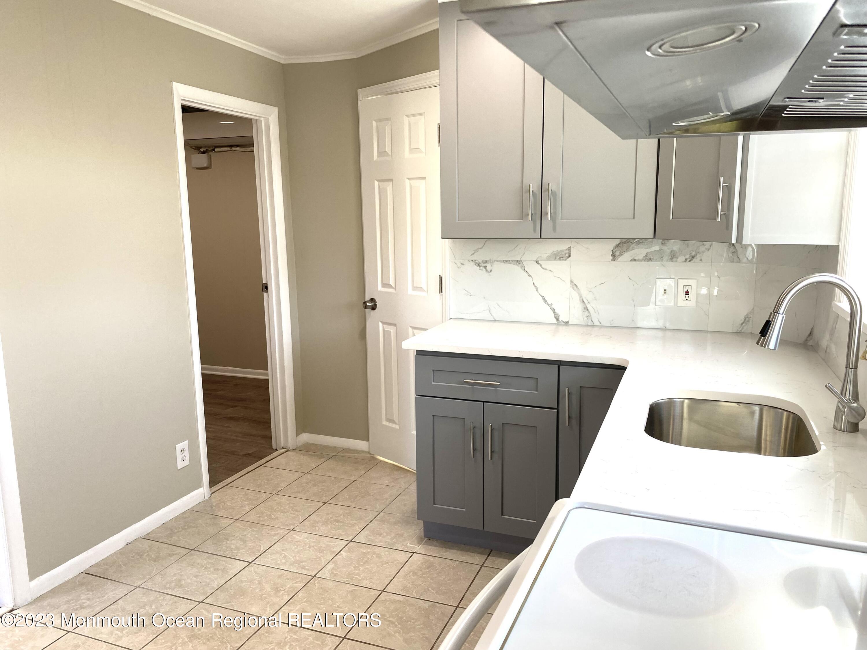 a kitchen with a cabinets and white appliances