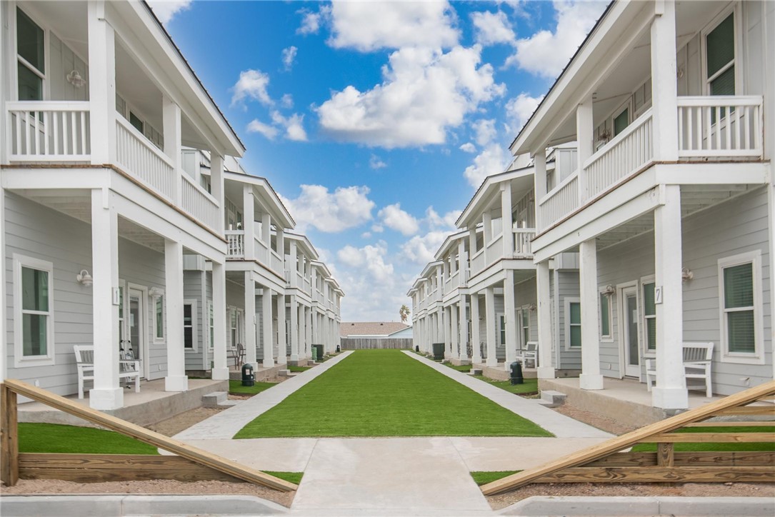 a view of a white apartments with large windows