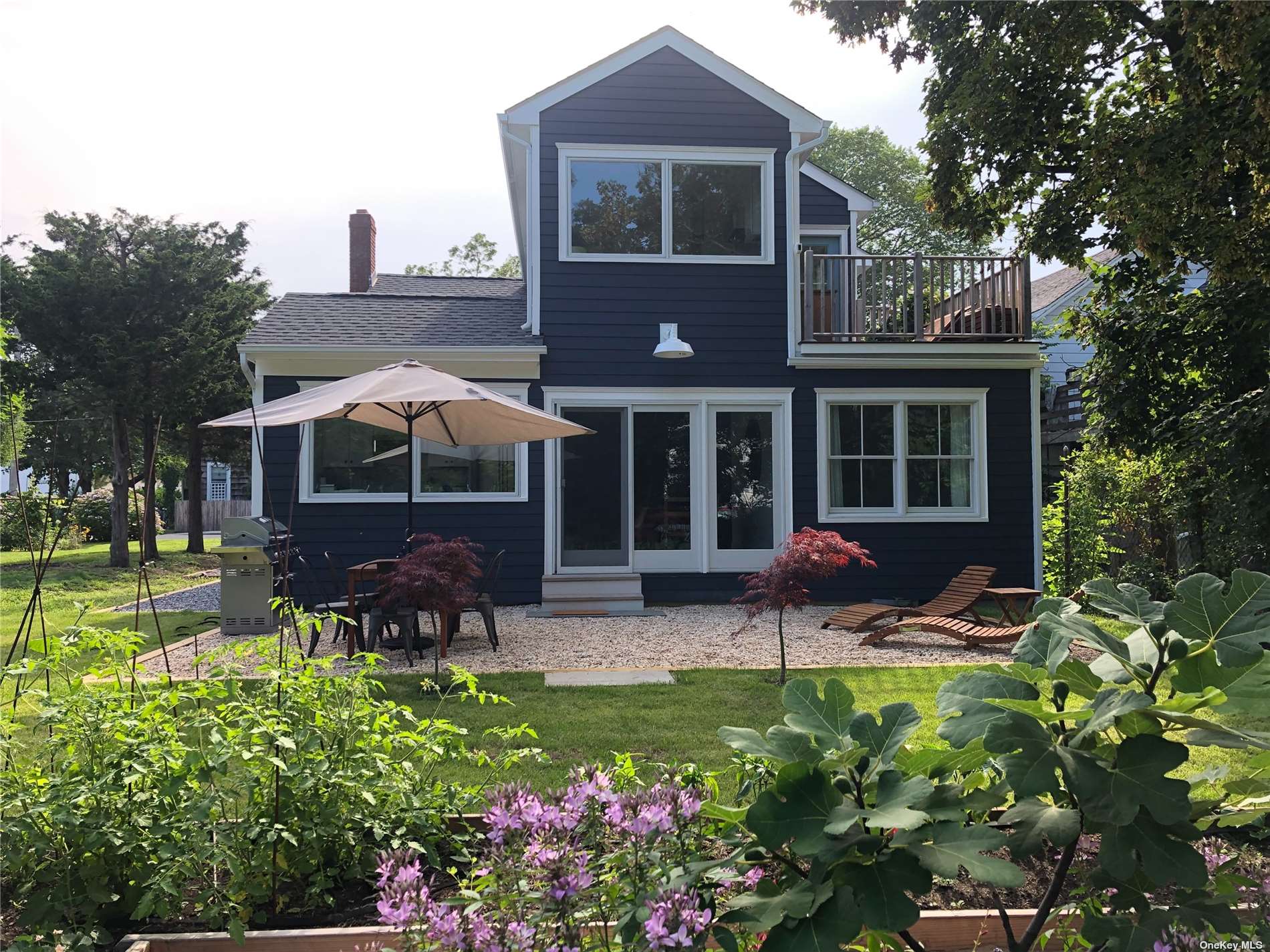 a view of a house with a yard and sitting area