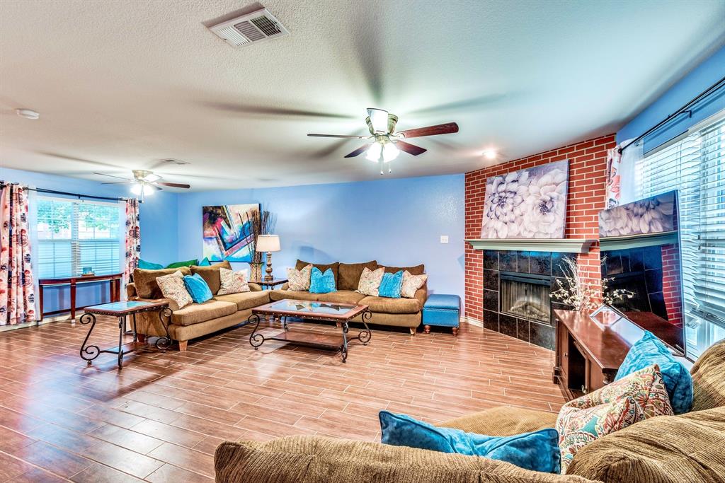 a living room with furniture kitchen view and a fireplace