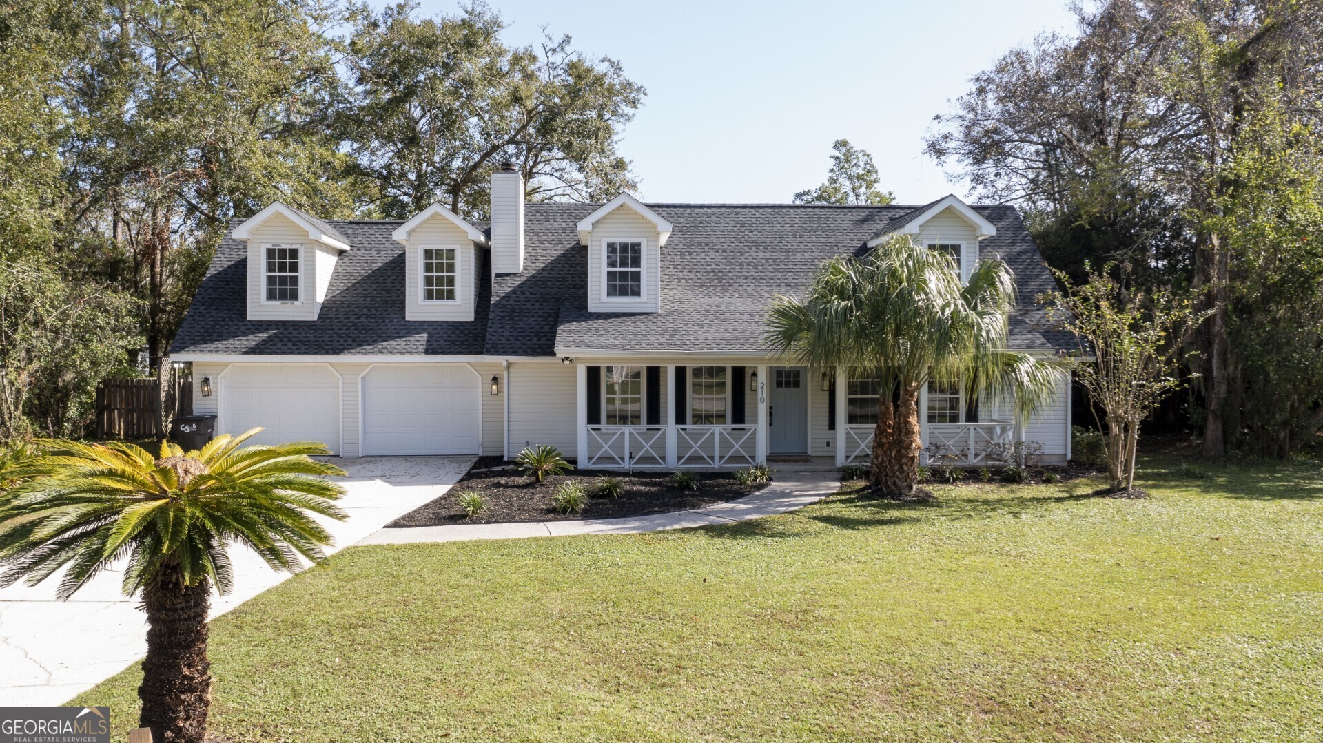 a front view of house with yard and trees