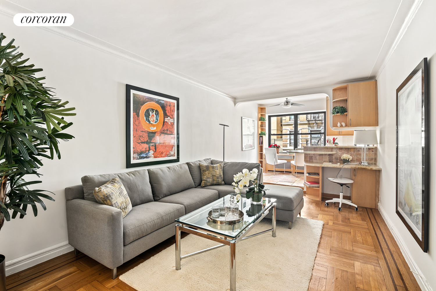 a living room with furniture and a potted plant