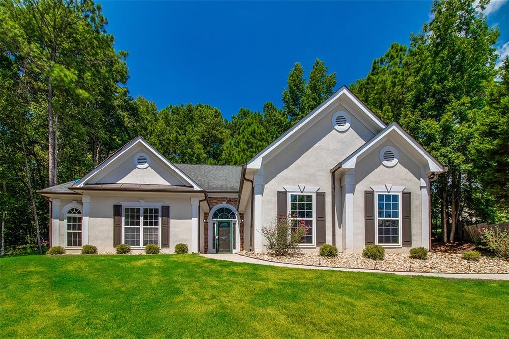 a front view of a house with a yard