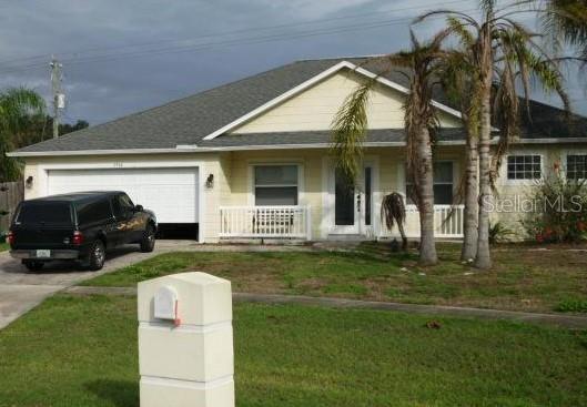 a view of a house with a yard porch and sitting area