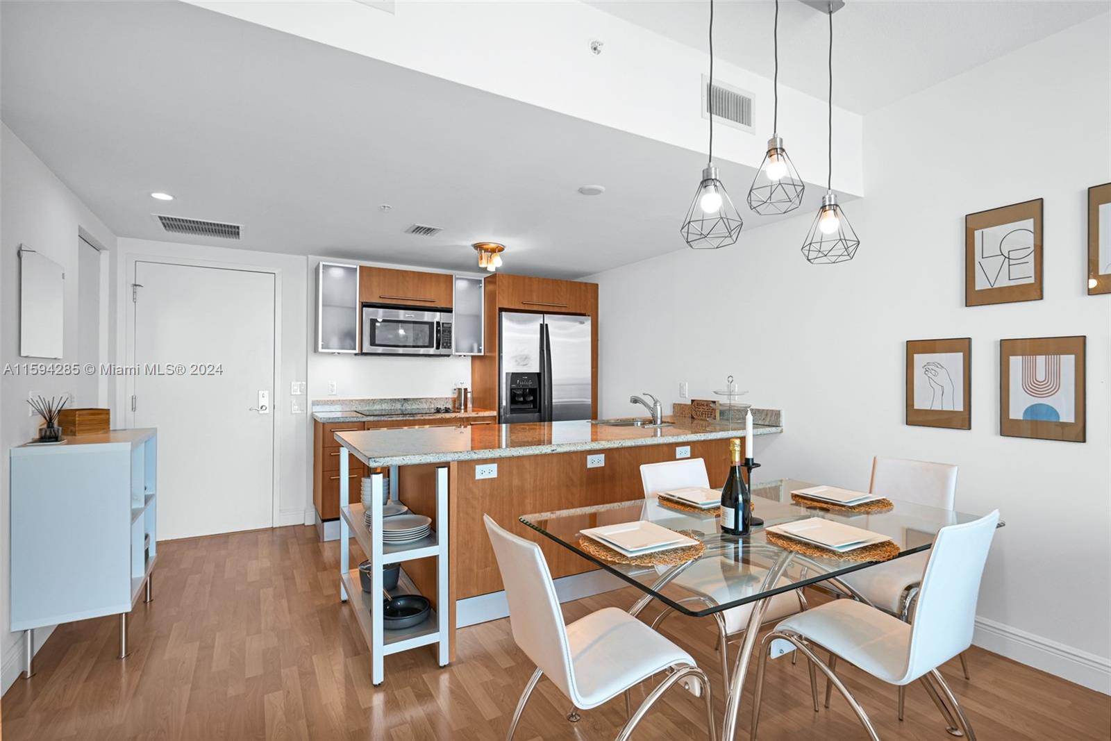 a view of a dining room with furniture wooden floor and chandelier