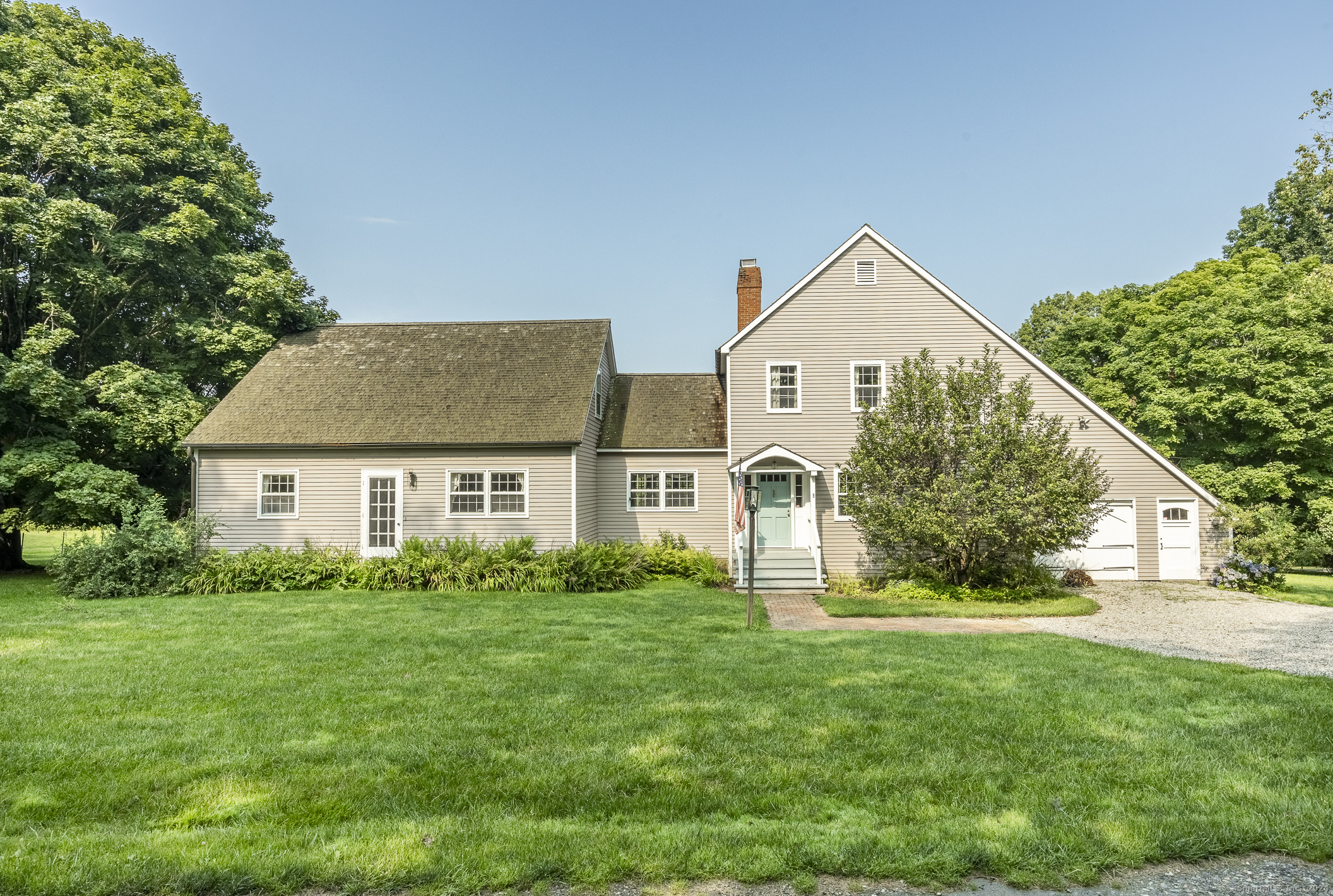 a front view of house with yard and green space