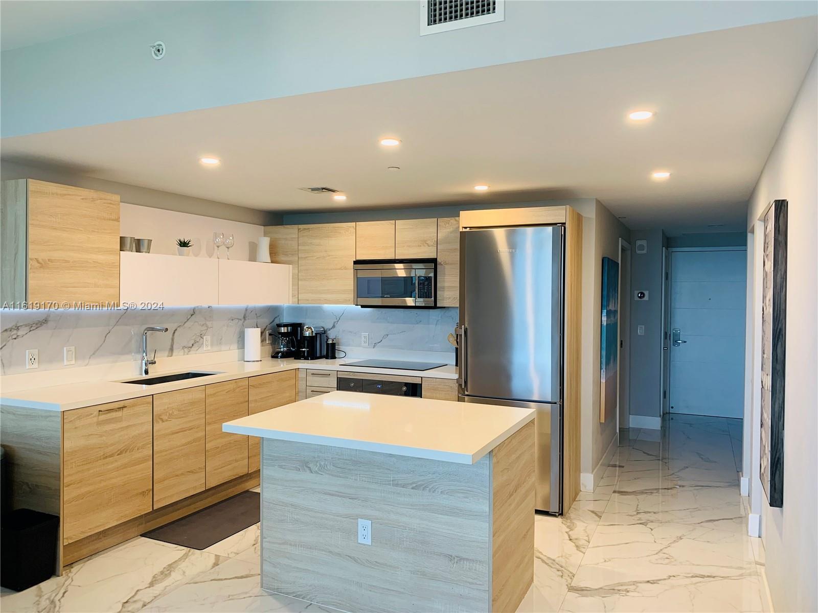 a kitchen with stainless steel appliances granite countertop a sink and cabinets