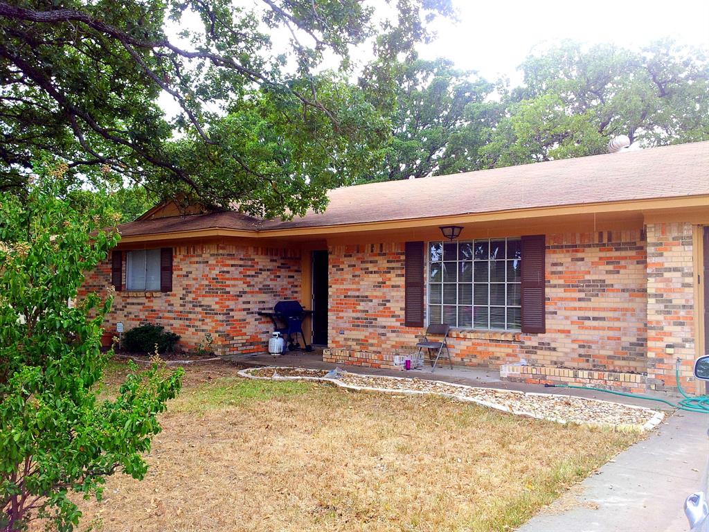 a front view of house with yard outdoor seating and barbeque oven