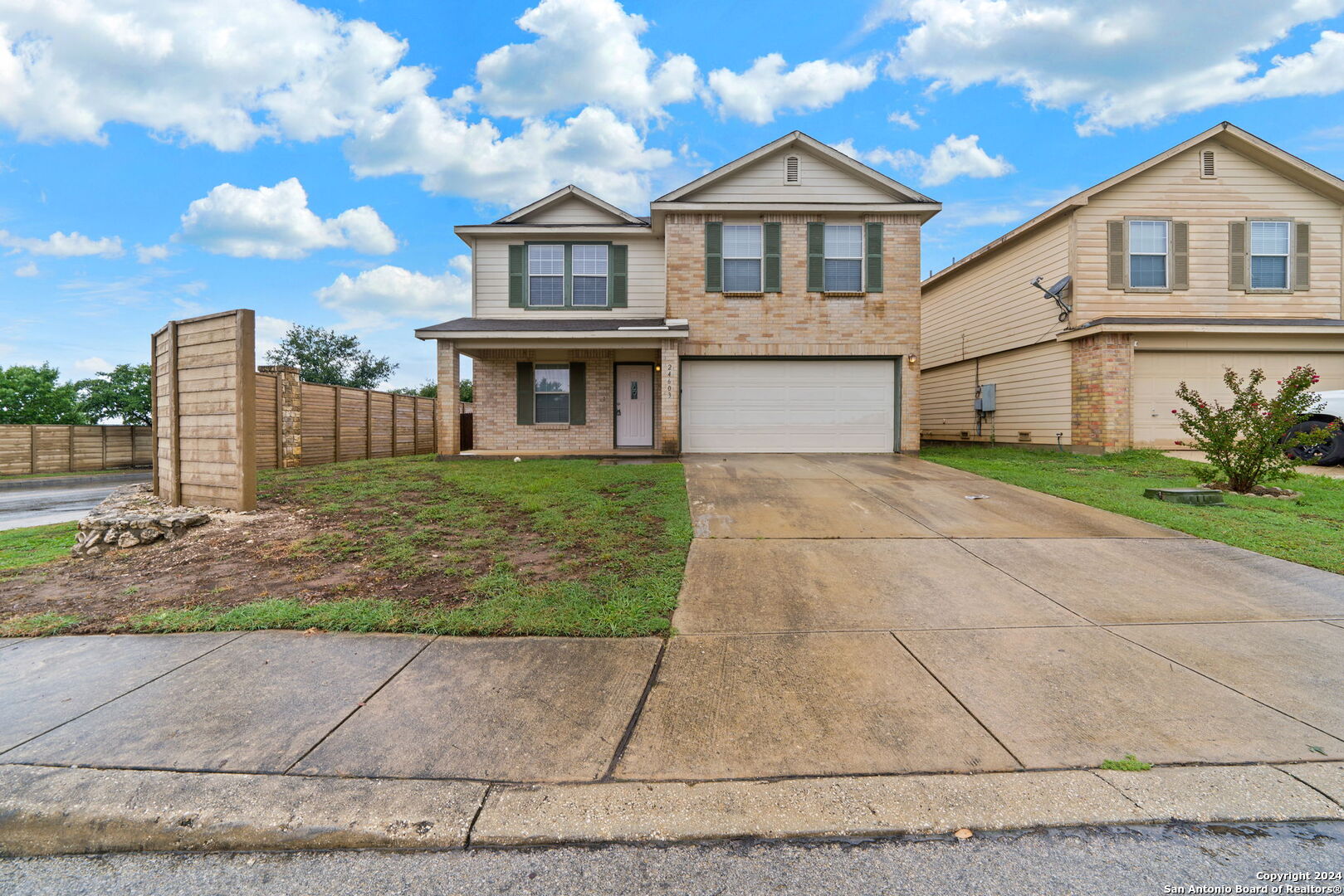 a front view of a house with a yard and garage