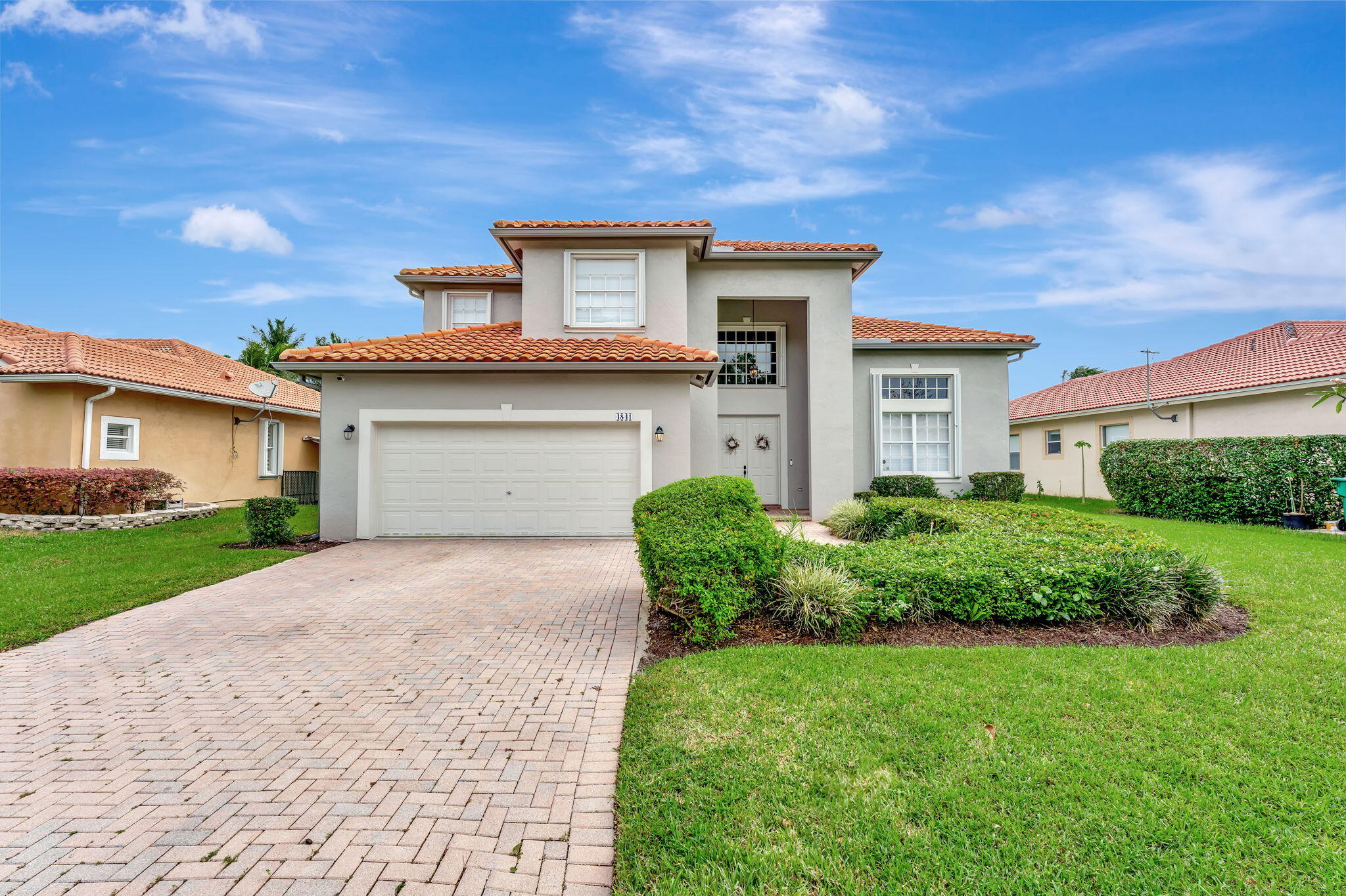 a front view of a house with a yard and garage