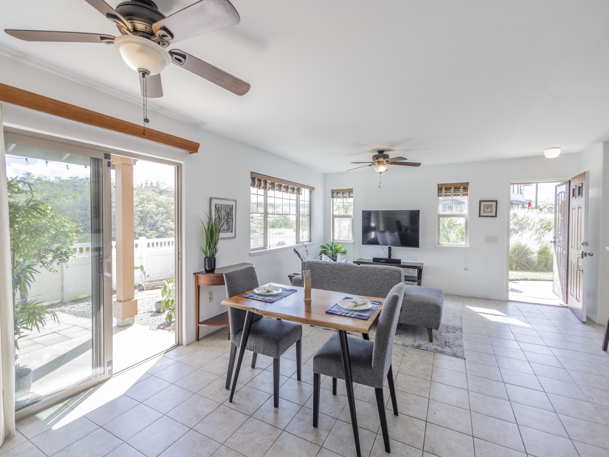 a dining room with furniture a chandelier and window