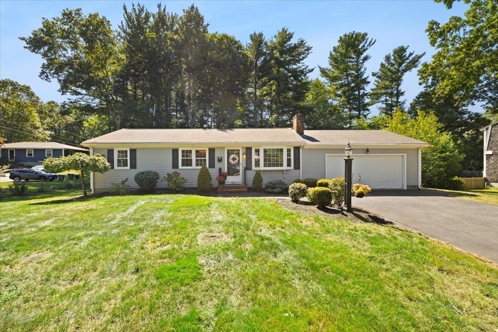 a view of a house with yard and sitting area