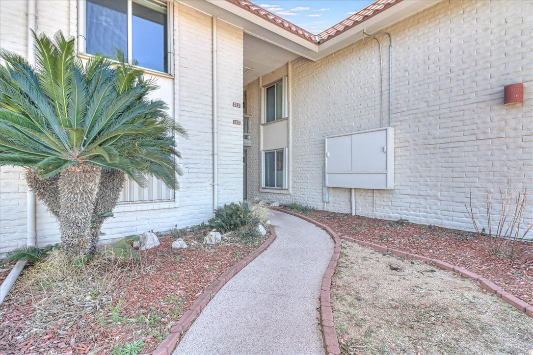 a row of palm trees in front of house