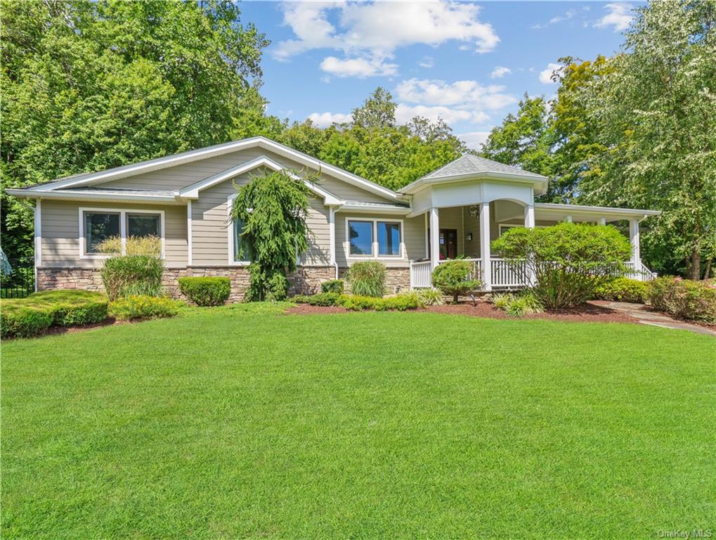 a front view of house with yard and green space