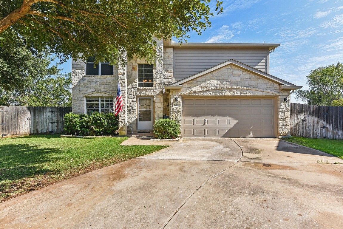 a front view of a house with a yard and garage