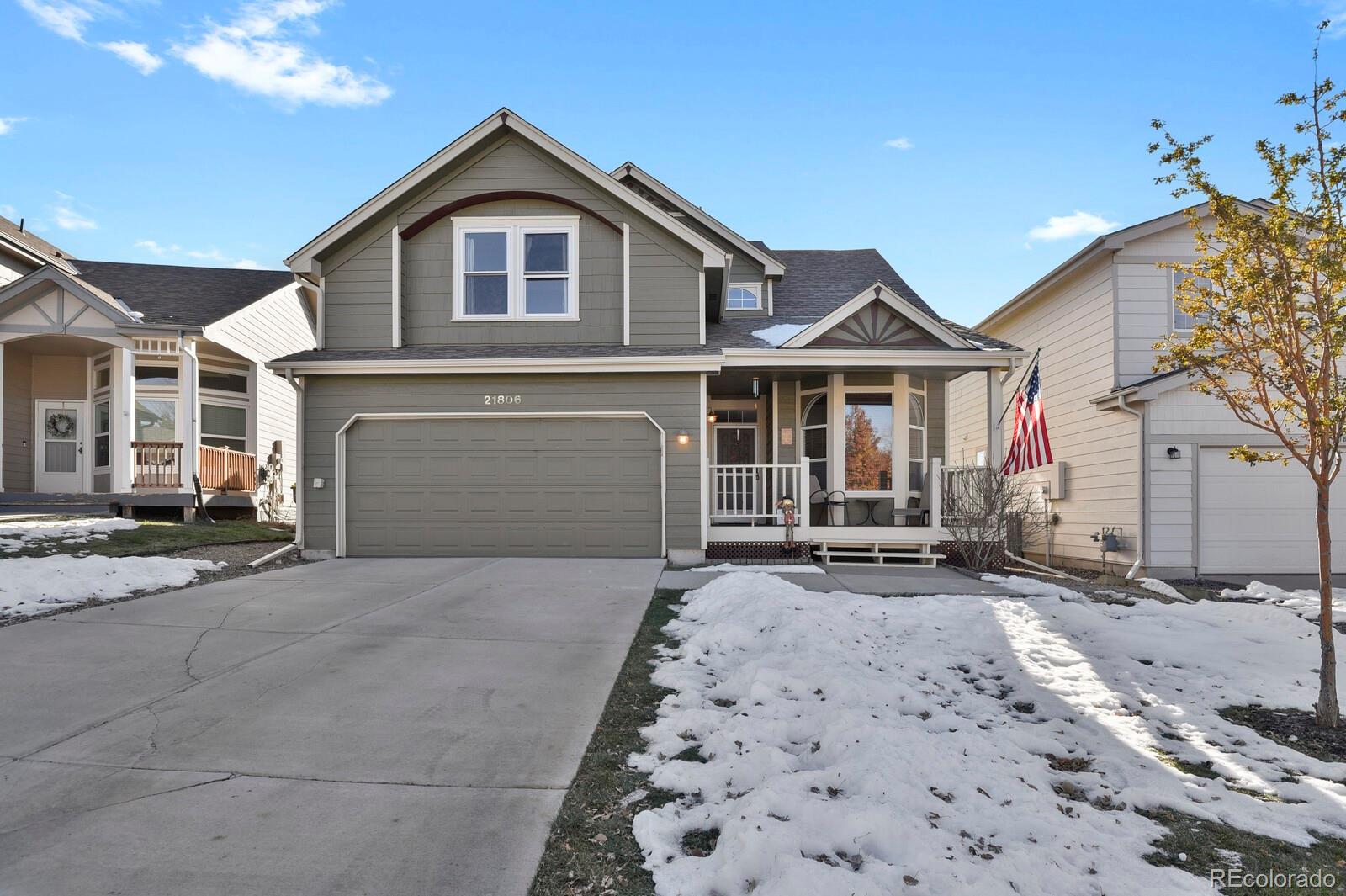 a front view of a house with a yard and parking space