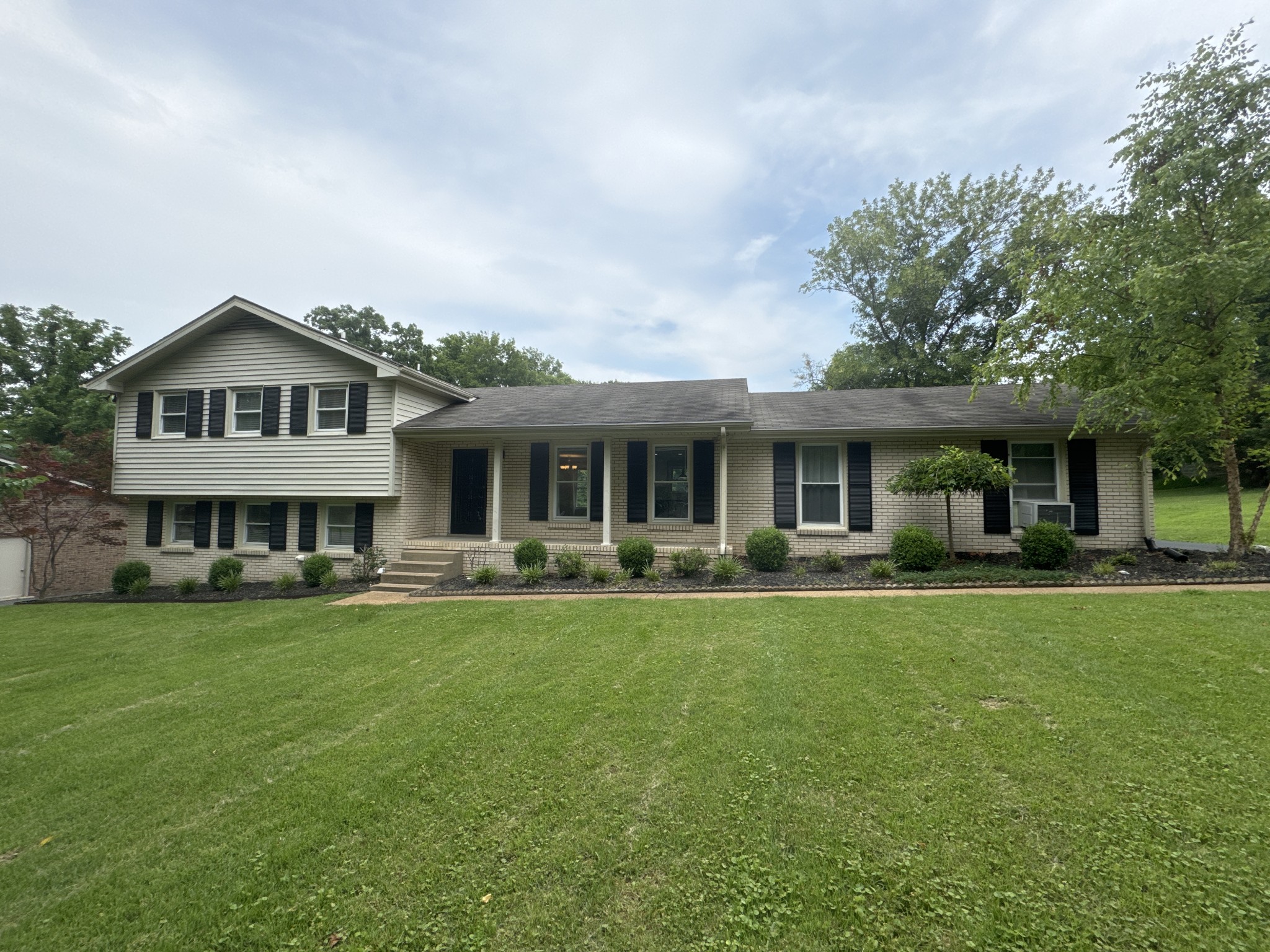 a front view of a house with swimming pool having outdoor seating