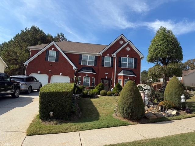 a front view of a house with a yard