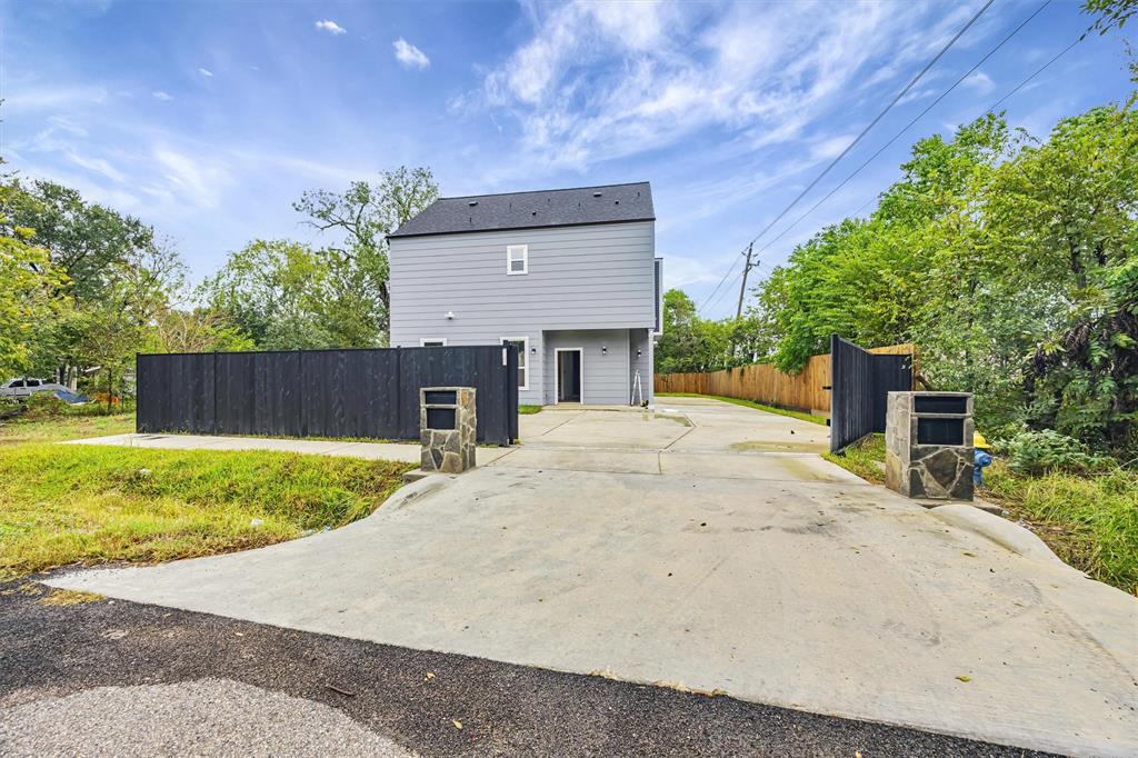 a front view of a house with a yard and a garage