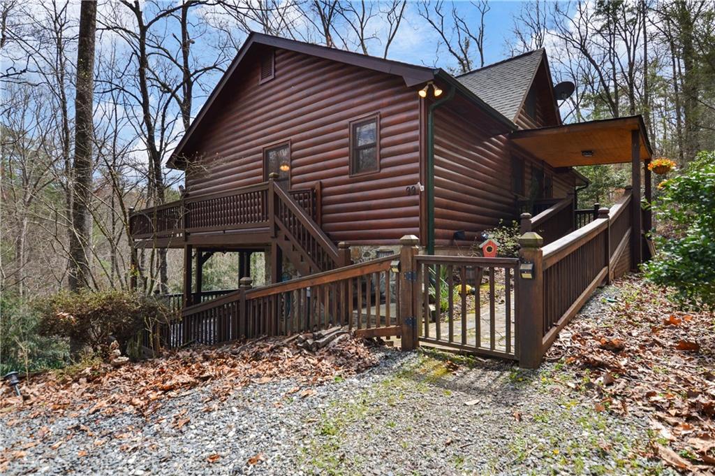 a backyard of a house with deck and outdoor seating