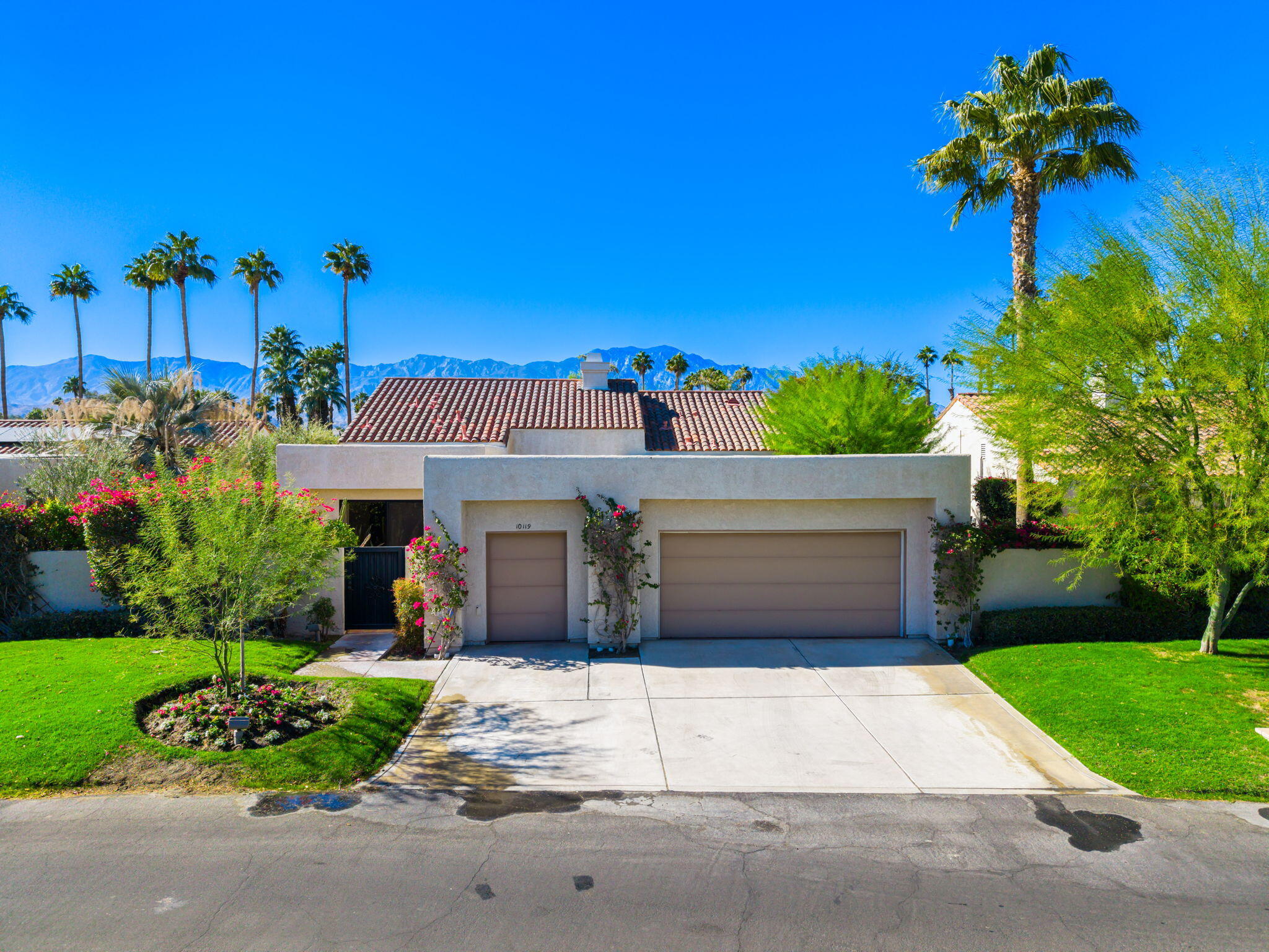 a view of a house with a yard and a garage