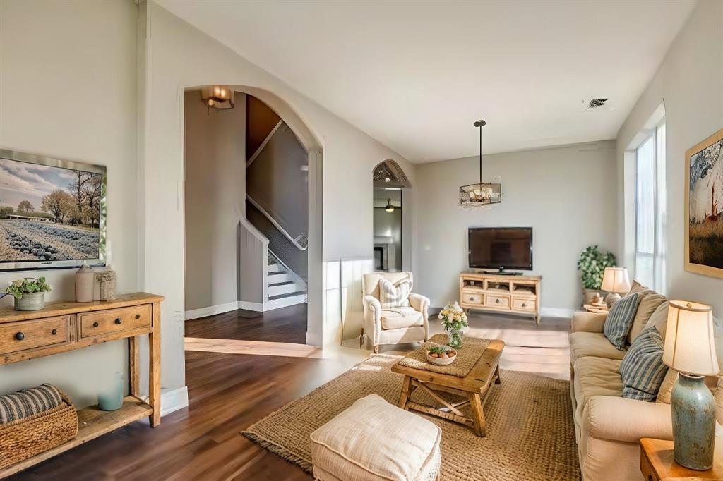 a living room with furniture a flat screen tv and a fireplace