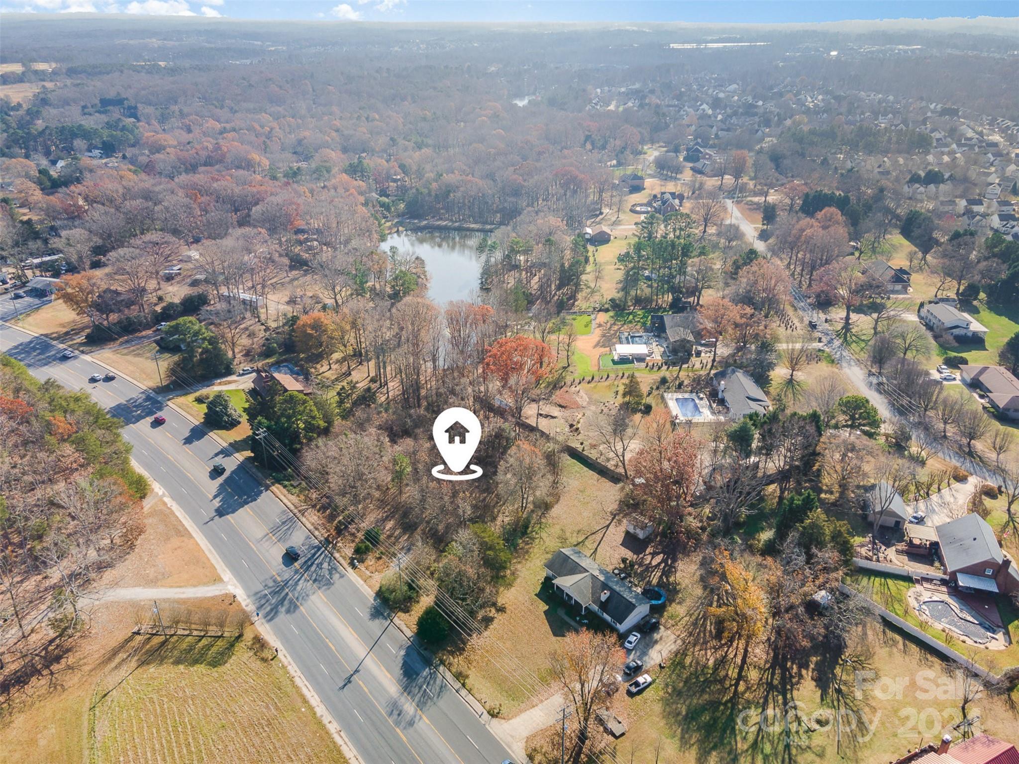 an aerial view of a house with a yard and mountain view in back