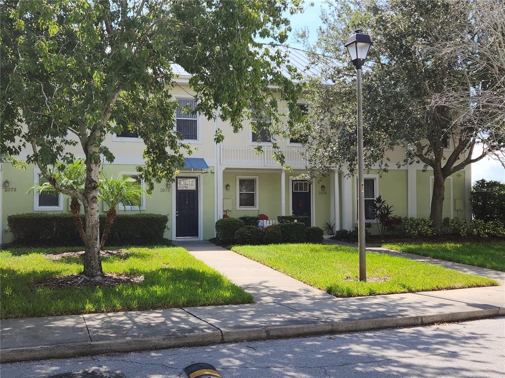 a view of a house with a swimming pool and a yard