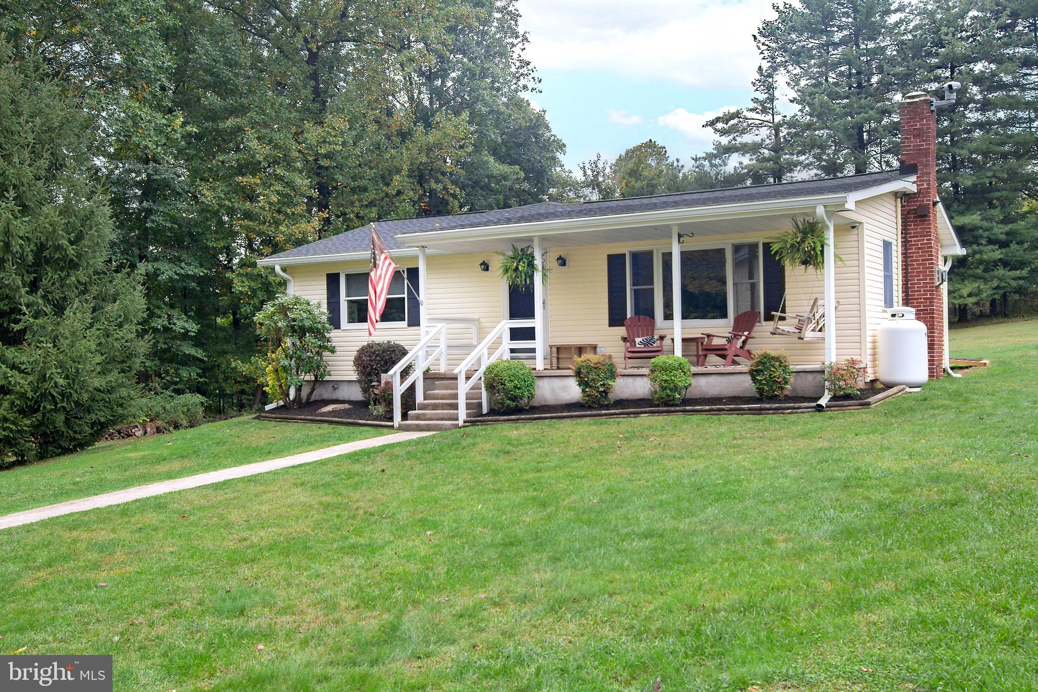 a front view of house with yard and outdoor seating