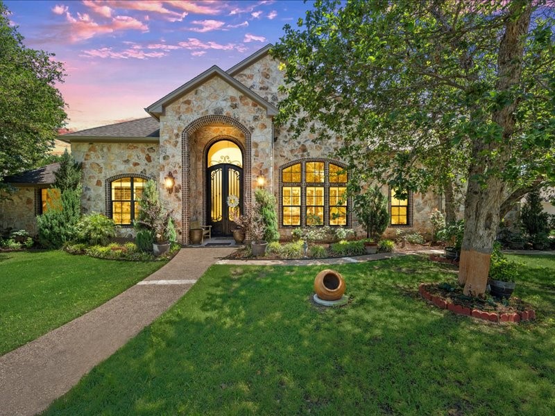 a view of a house with backyard sitting area and garden