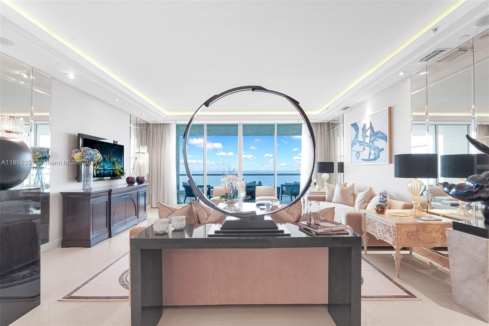 a living room with stainless steel appliances kitchen island granite countertop a table and chairs in it