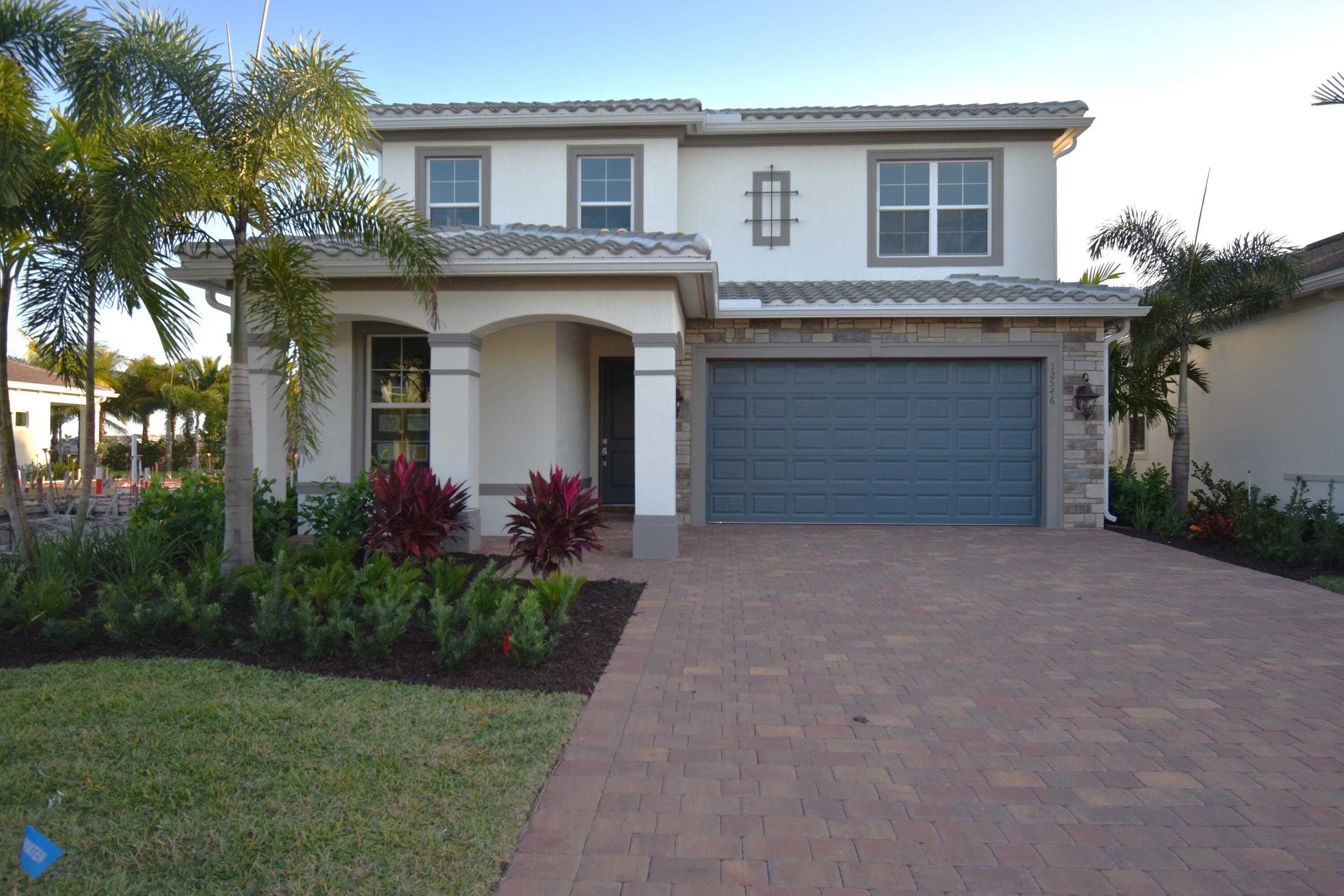 a front view of a house with a garden and entryway