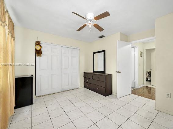 a room with a bed and a ceiling fan