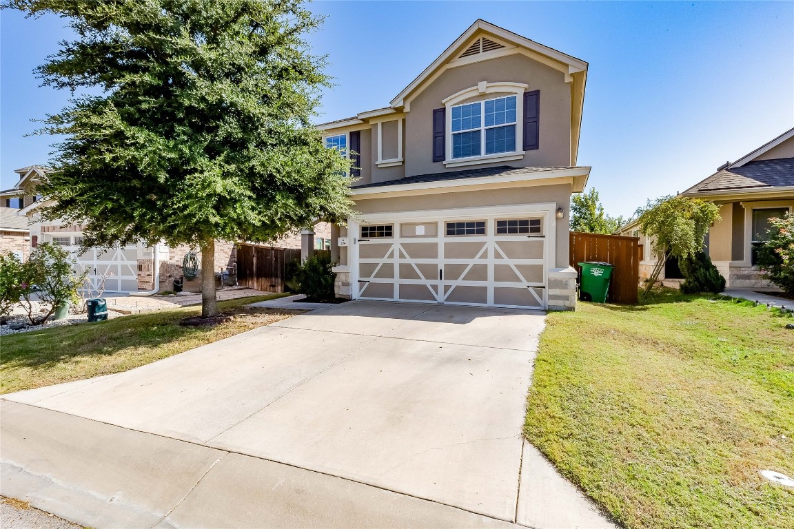 a front view of a house with a yard and garage