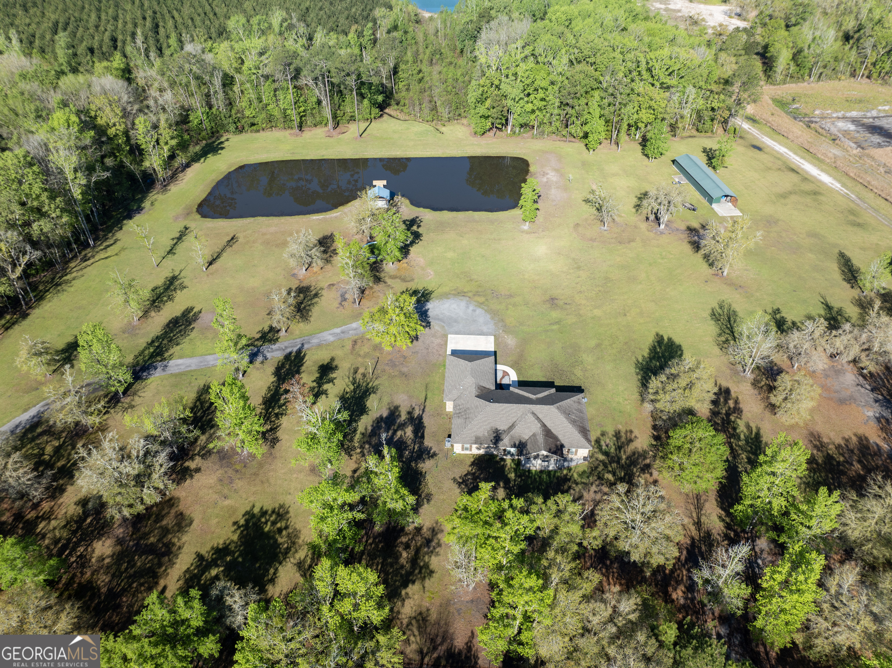 an aerial view of a house with a yard