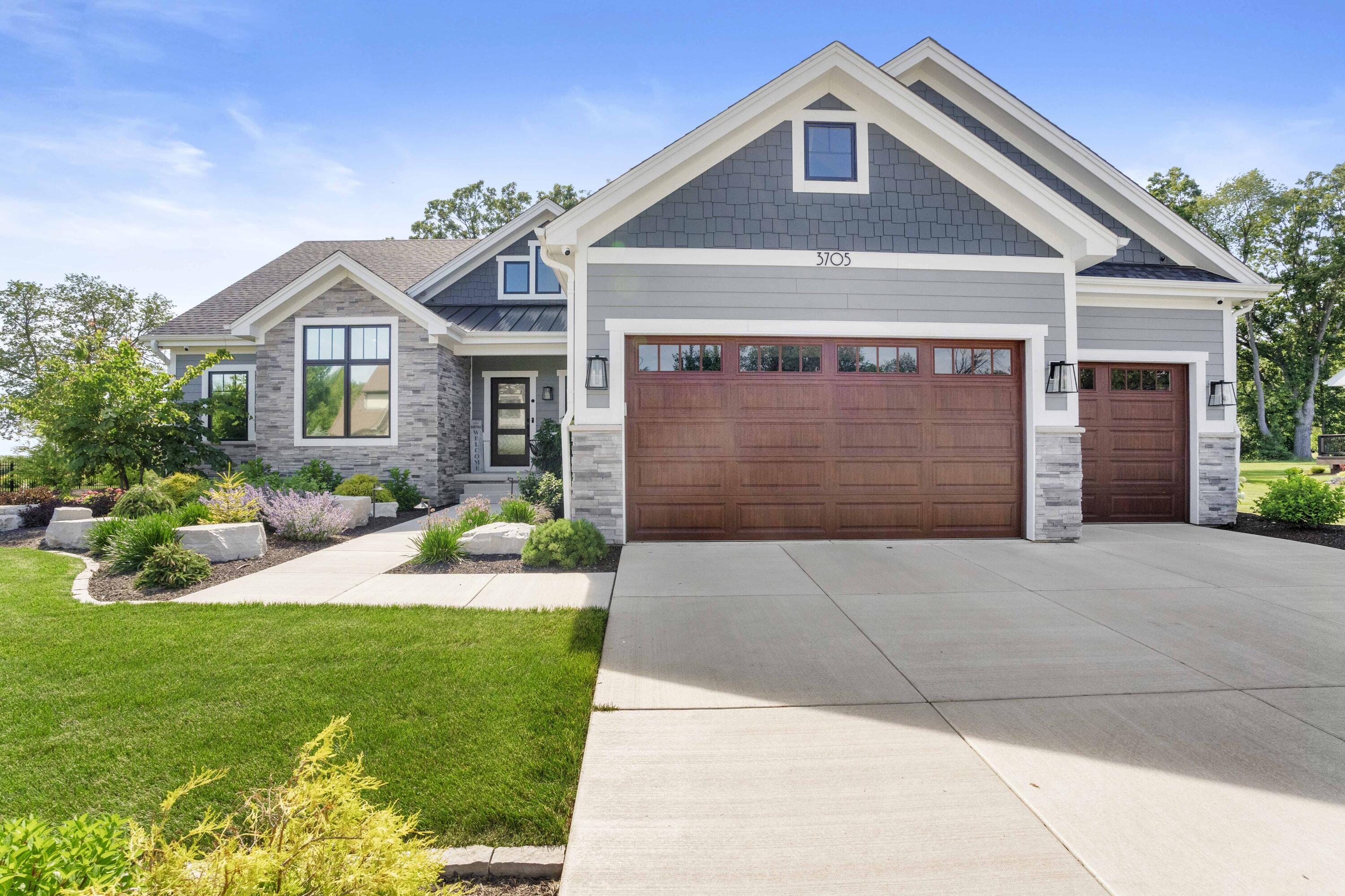 a front view of a house with a yard and garage