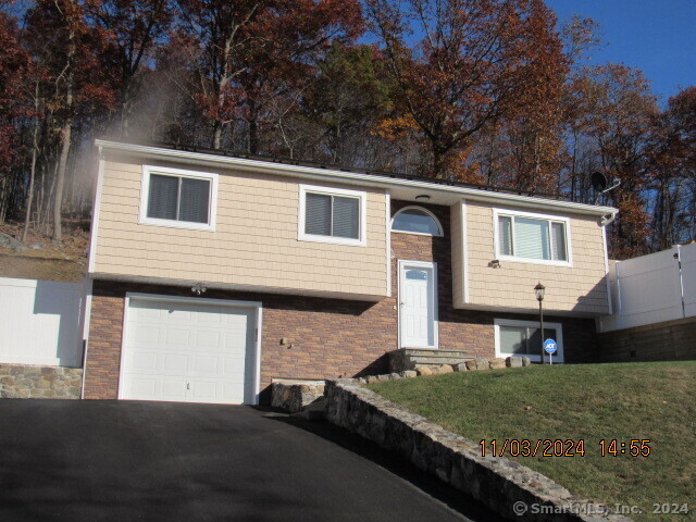 a front view of a house with a garden and yard