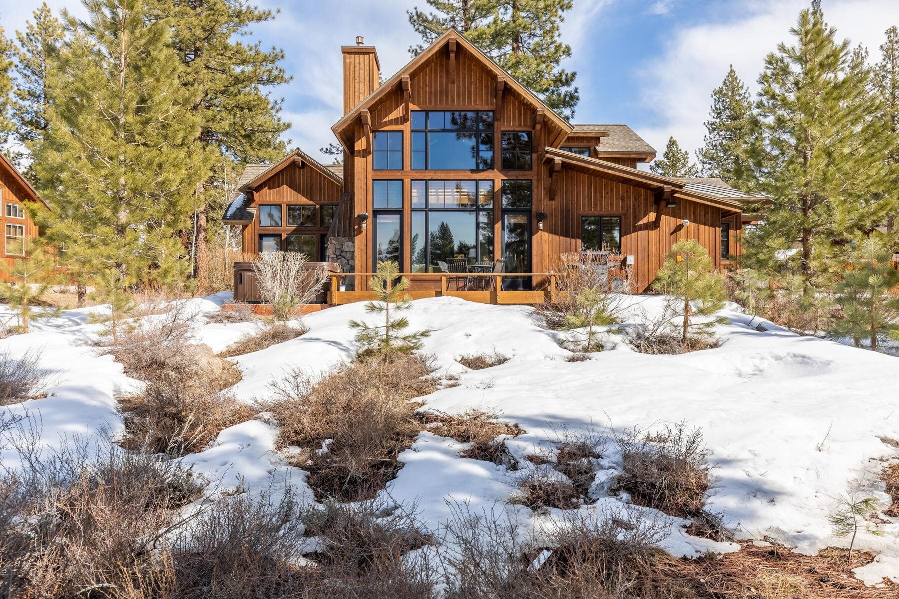 a front view of a house with a yard covered in snow