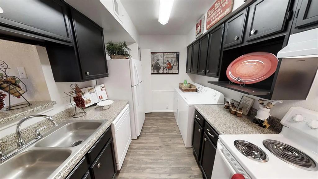 a kitchen with a sink stove and cabinets